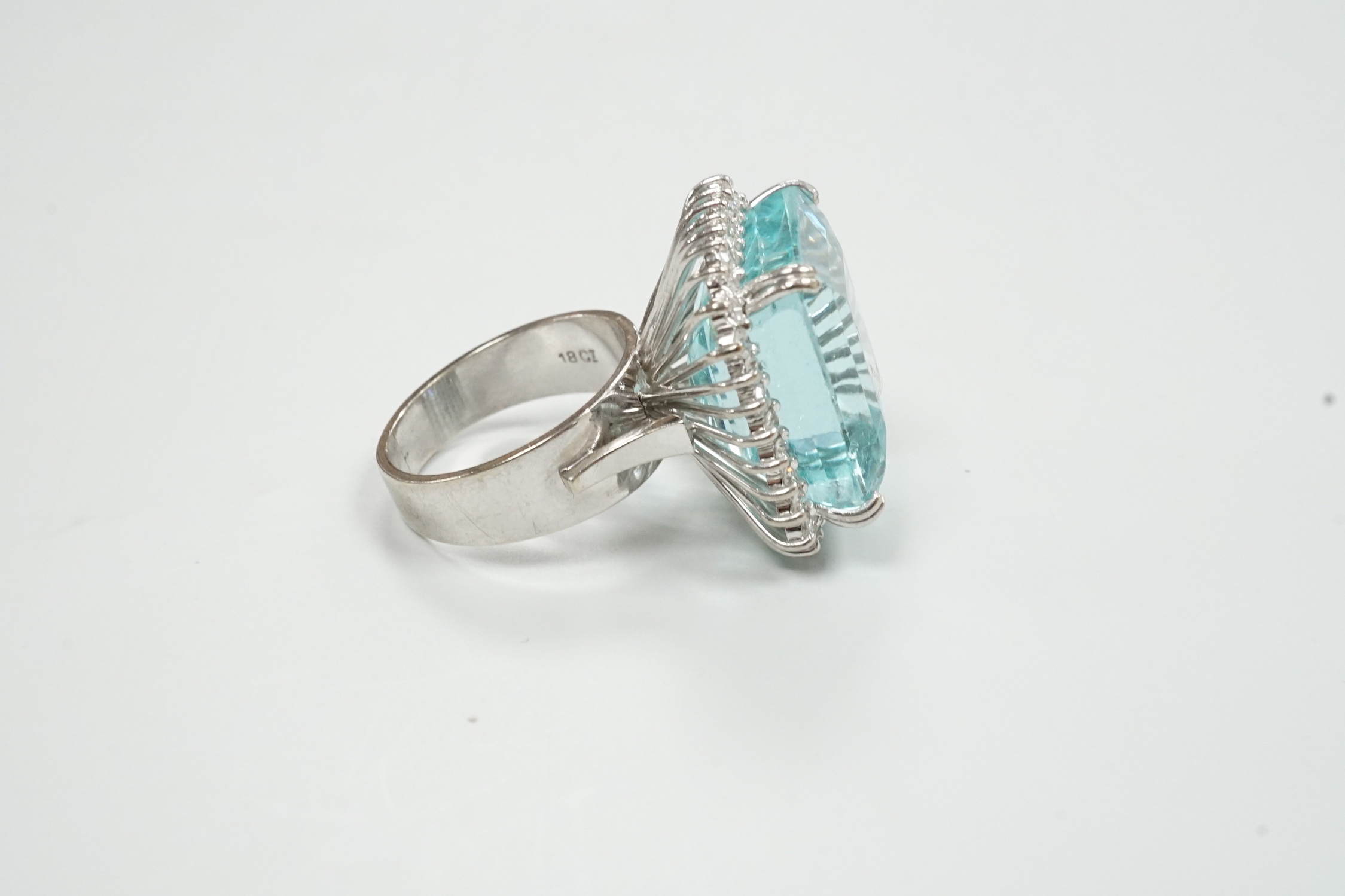 A modern 18ct white metal, simulated aquamarine and diamond chip cluster set dress ring, size P/Q, gross weight 16.3 grams